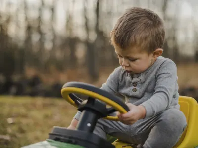 Little boy on a toy tractor